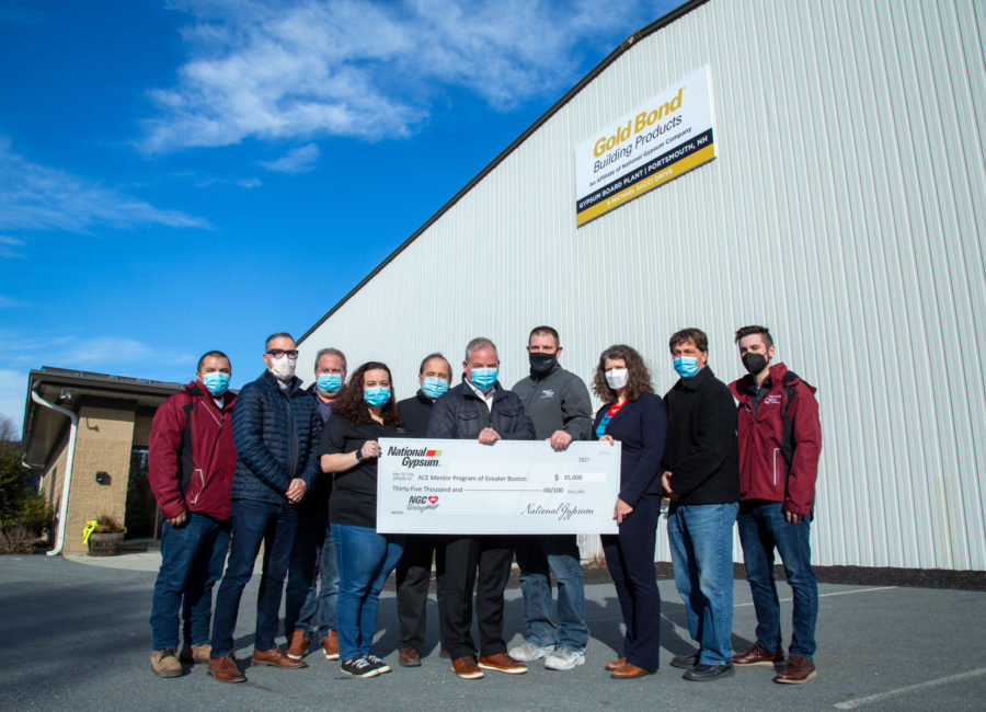 Image of representatives of ACE Mentor Program accepting a check for $35,000 from National Gypsum, in front of the Portsmouth #GoldBondProducts plant.